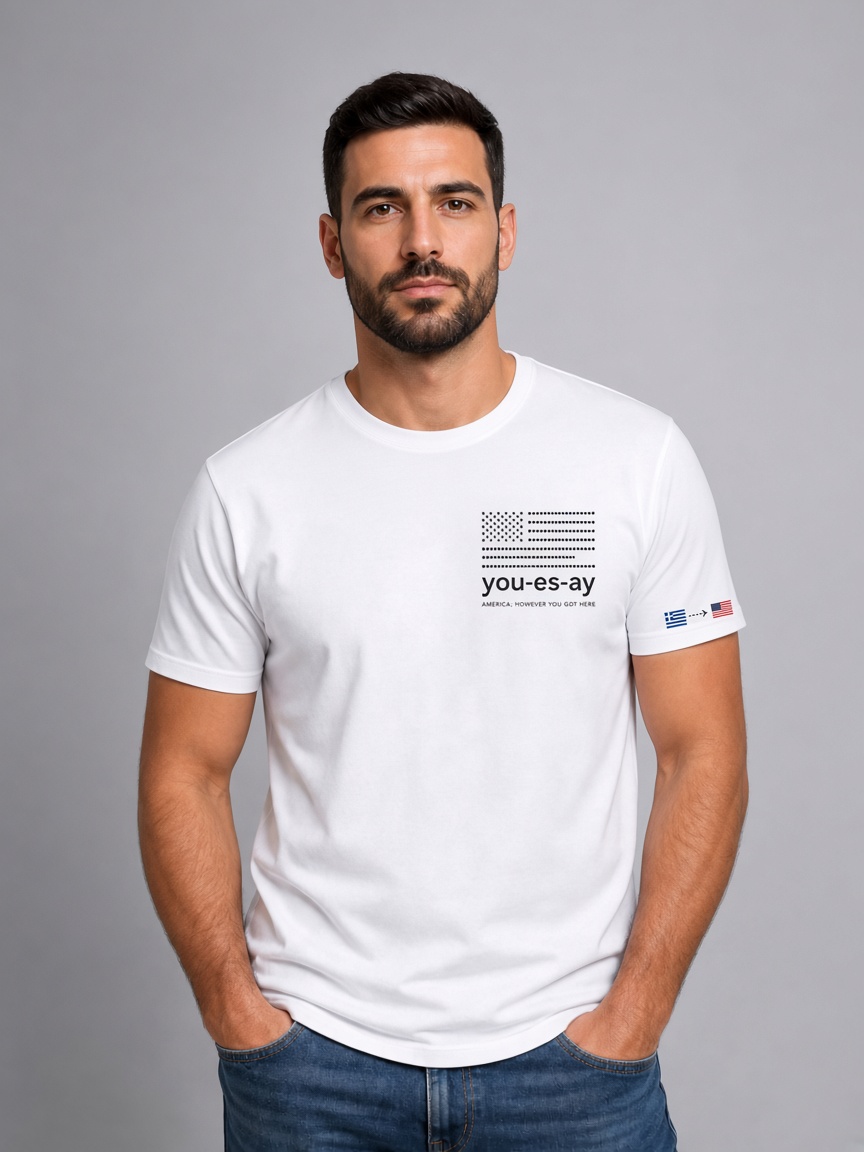 Man wearing the white Origin Tee with Greece to USA on the sleeve